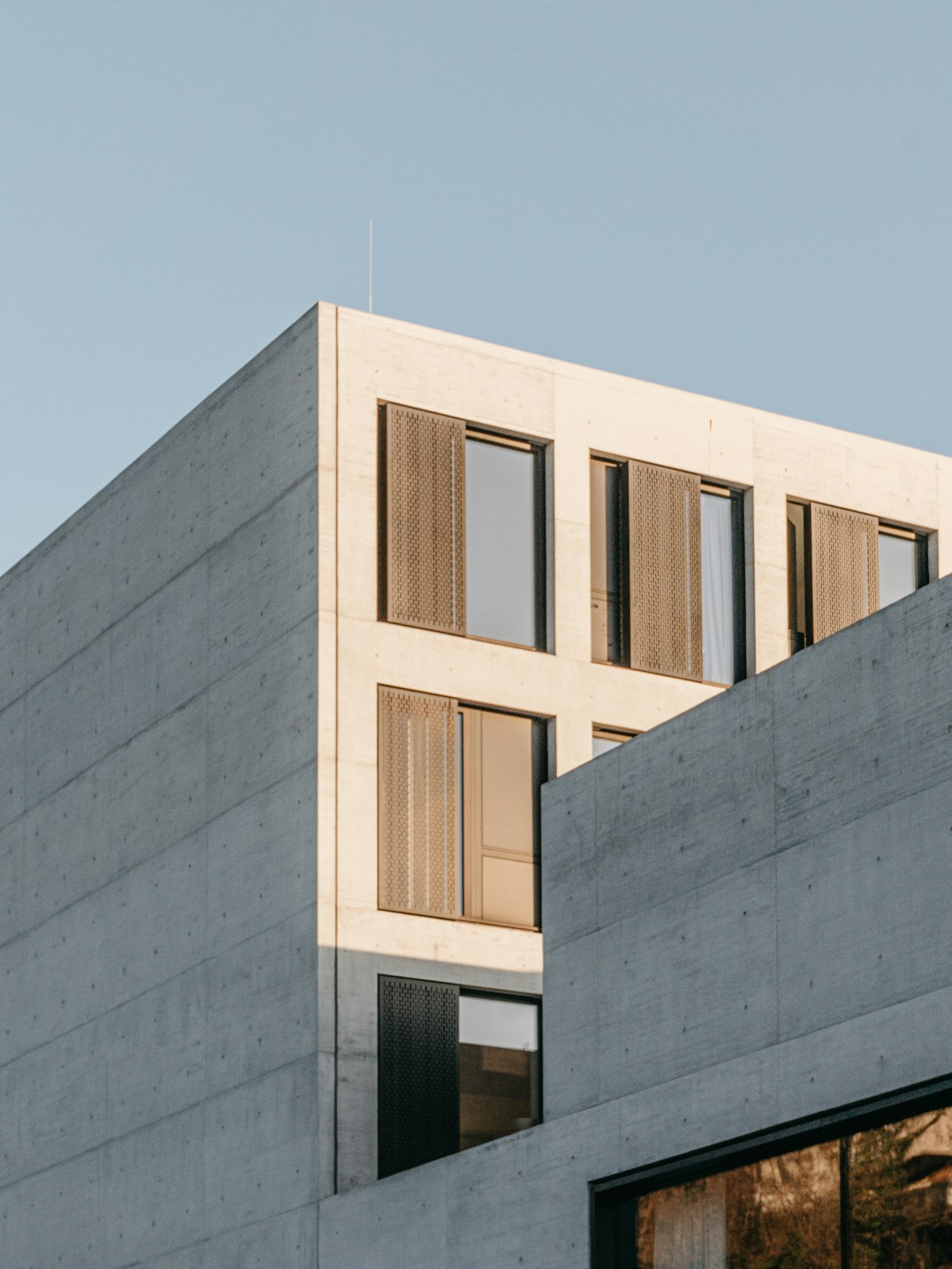 Modern gray concrete building facade under blue sky in Argentina